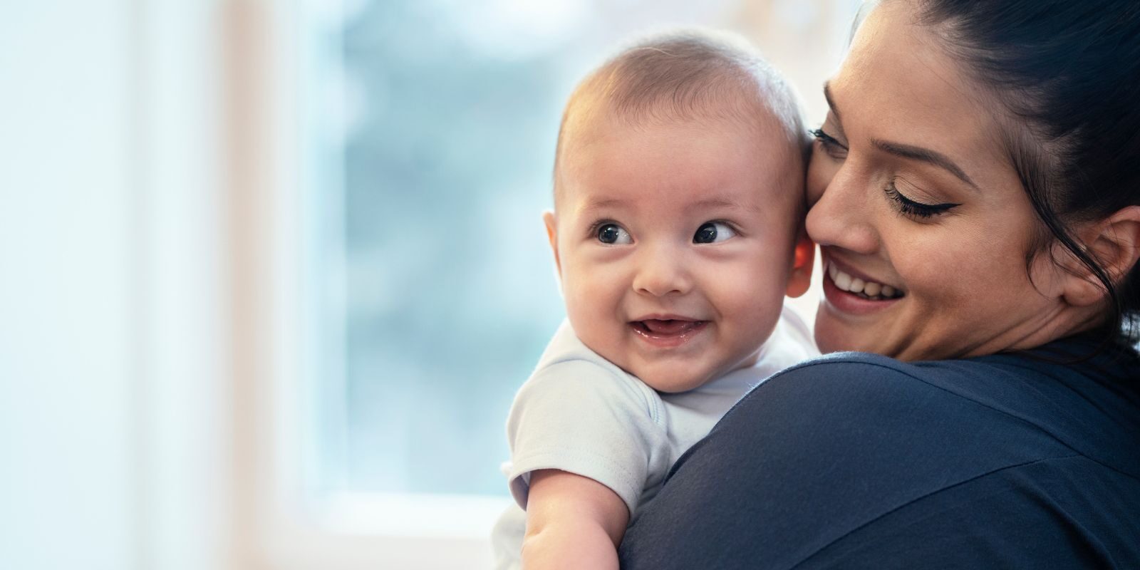 Photo of mother kissing baby